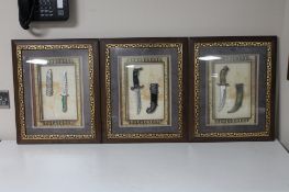 Three Eastern knives in sheathes in display frame