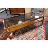 A mid 20th century teak smoked glass topped coffee table