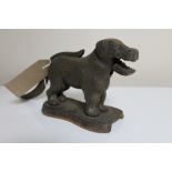 An antique metal nut cracker in the form of a dog