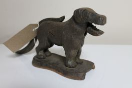 An antique metal nut cracker in the form of a dog