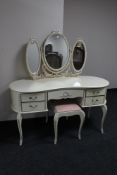 A cream and gilt dressing table with dressing mirror and stool
