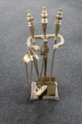 An antique brass companion stand,