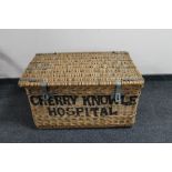 A wicker laundry hamper marked Cherry Knowle Hospital