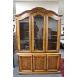 An American style dome topped triple door display cabinet