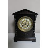 An early 20th century French oak mantel clock and brass and enamelled dial