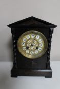 An early 20th century French oak mantel clock and brass and enamelled dial