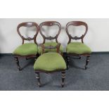 A set of four Victorian mahogany balloon backed chairs (one back cut-down)