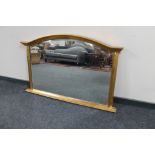 A Victorian style arch topped bevelled overmantel mirror