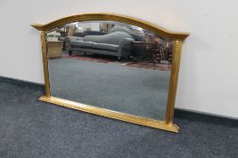 A Victorian style arch topped bevelled overmantel mirror