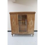 A 20th century stripped oak triple door cabinet