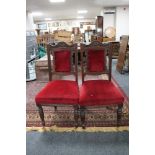 A pair of late Victorian mahogany dining chairs upholstered in a red dralon