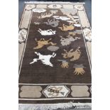 A fringed Chinese embossed rug depicting horses on brown ground