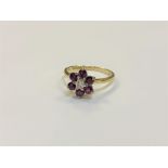 An 18ct gold ruby and diamond cluster ring, size O/P, 3.2g.
