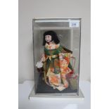 A 20th Century doll - Dancing Geisha in Full Costume, on fixed base, in perspex display cabinet,