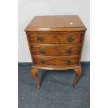 An early 20th century walnut three drawer chest