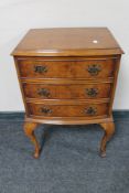 An early 20th century walnut three drawer chest