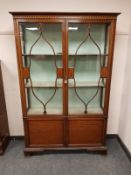 A late Victorian inlaid mahogany display cabinet,
