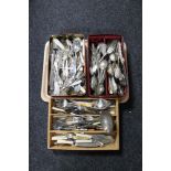 Two tins and a cutlery drawer of plated and stainless steel cutlery