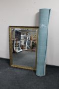 A gilt framed bevelled mirror together with a contemporary rug