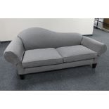 A contemporary settee in grey fabric