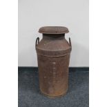 An early 20th century twin handled milk churn