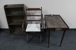 An antique folding mahogany chair together with a butler's tray on stand and set of bookshelves