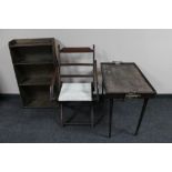 An antique folding mahogany chair together with a butler's tray on stand and set of bookshelves