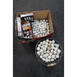 A quantity of boxed and unboxed golf balls