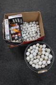 A quantity of boxed and unboxed golf balls