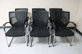 A set of six black Sipis office armchairs on tubular metal legs