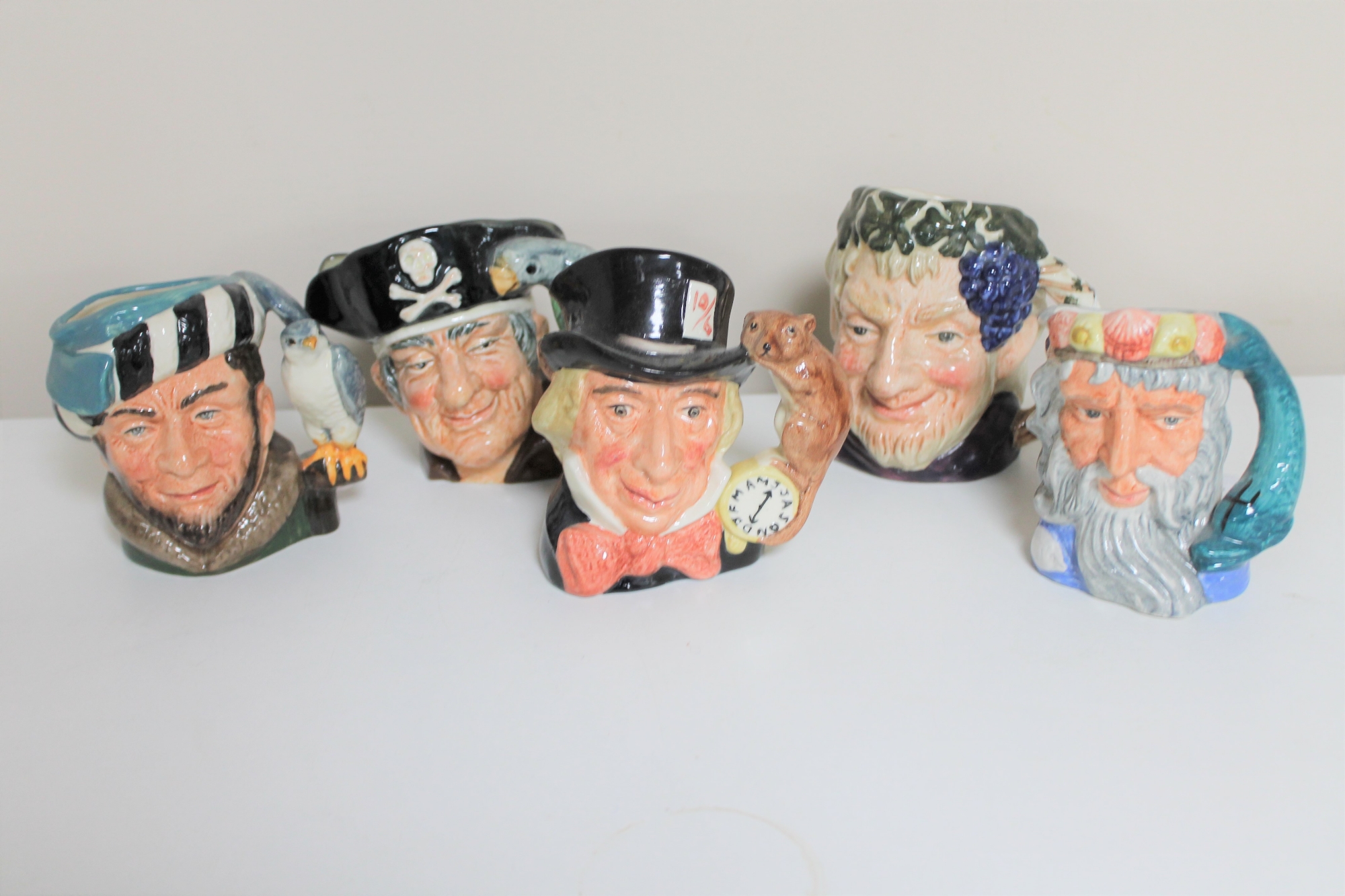 Five small Royal Doulton character jugs - Long John Silver, The Falconer,