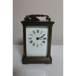 An antique brass cased eight day carriage clock with key