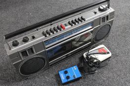 A Sanyo radio with twin cassette deck together with a Ferguson walkman and headphone,
