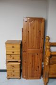 A contemporary pine triple door wardrobe (dismantled) and a pair of pine bedside chests