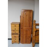 A contemporary pine triple door wardrobe (dismantled) and a pair of pine bedside chests