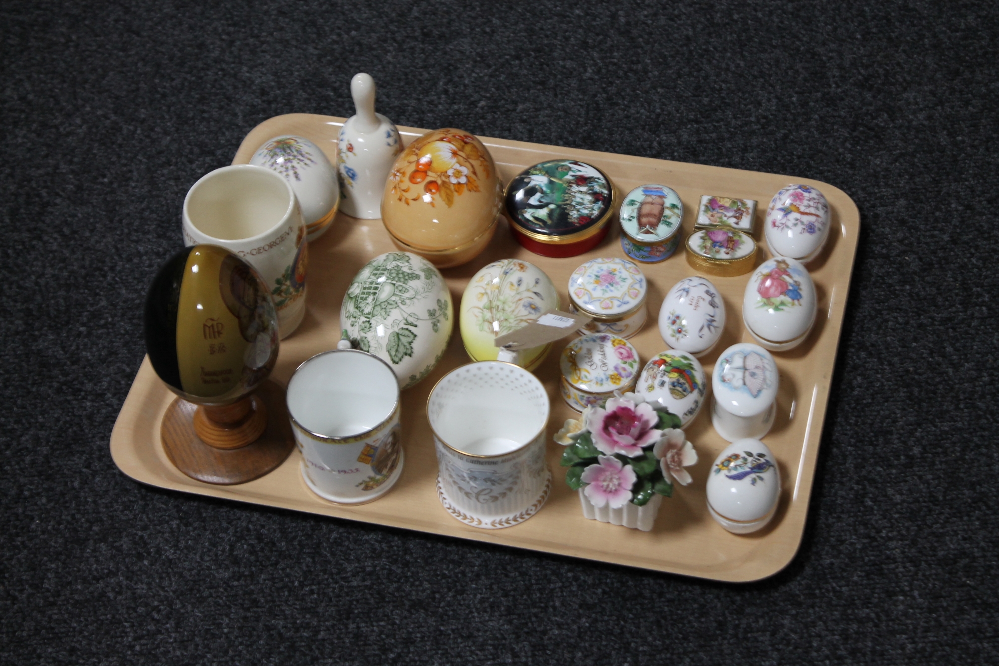 A tray of collection of china eggs and trinket boxes, china flower posy,