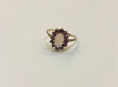 A yellow gold opal and ruby cluster ring, size N/O, 1.9g (hallmarks rubbed).