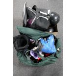 A box and a holdall of ski boots and helmets