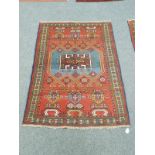 A Caucasian rug on red ground,