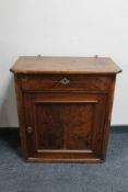 A 19th century mahogany cupboard fitted a drawer above