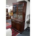 An inlaid mahogany Regency style bookcase