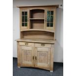 An early 20th century continental oak dresser fitted cupboards and drawers beneath