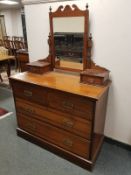 An Edwardian walnut four drawer dressing chest,