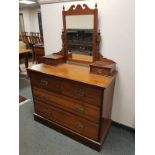 An Edwardian walnut four drawer dressing chest,