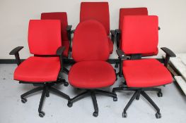 Six red adjustable swivel office armchairs
