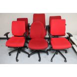 Six red adjustable swivel office armchairs