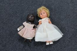 An early 20th century doll and a plastic doll