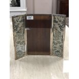 A George V silver three-fold photograph frame inset with two Chinese silk panels,