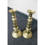 A pair of antique brass candlesticks