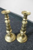 A pair of antique brass candlesticks